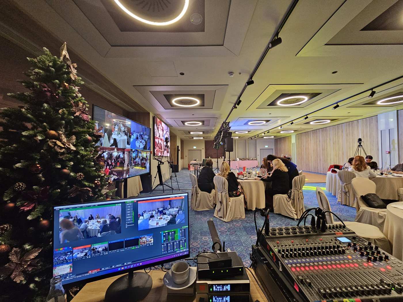 Video duplex between two rooms at a hybrid event, with control desk and LED screen